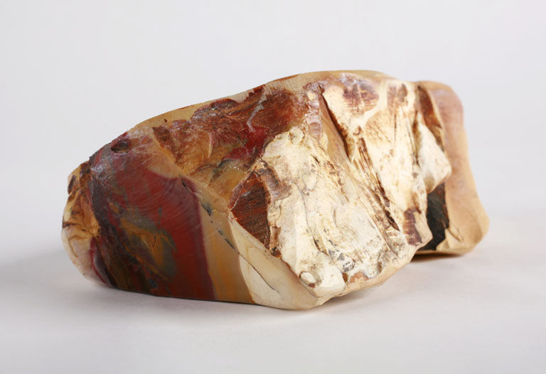 A chunk of rough cream, yellow, and red stripped mookate.